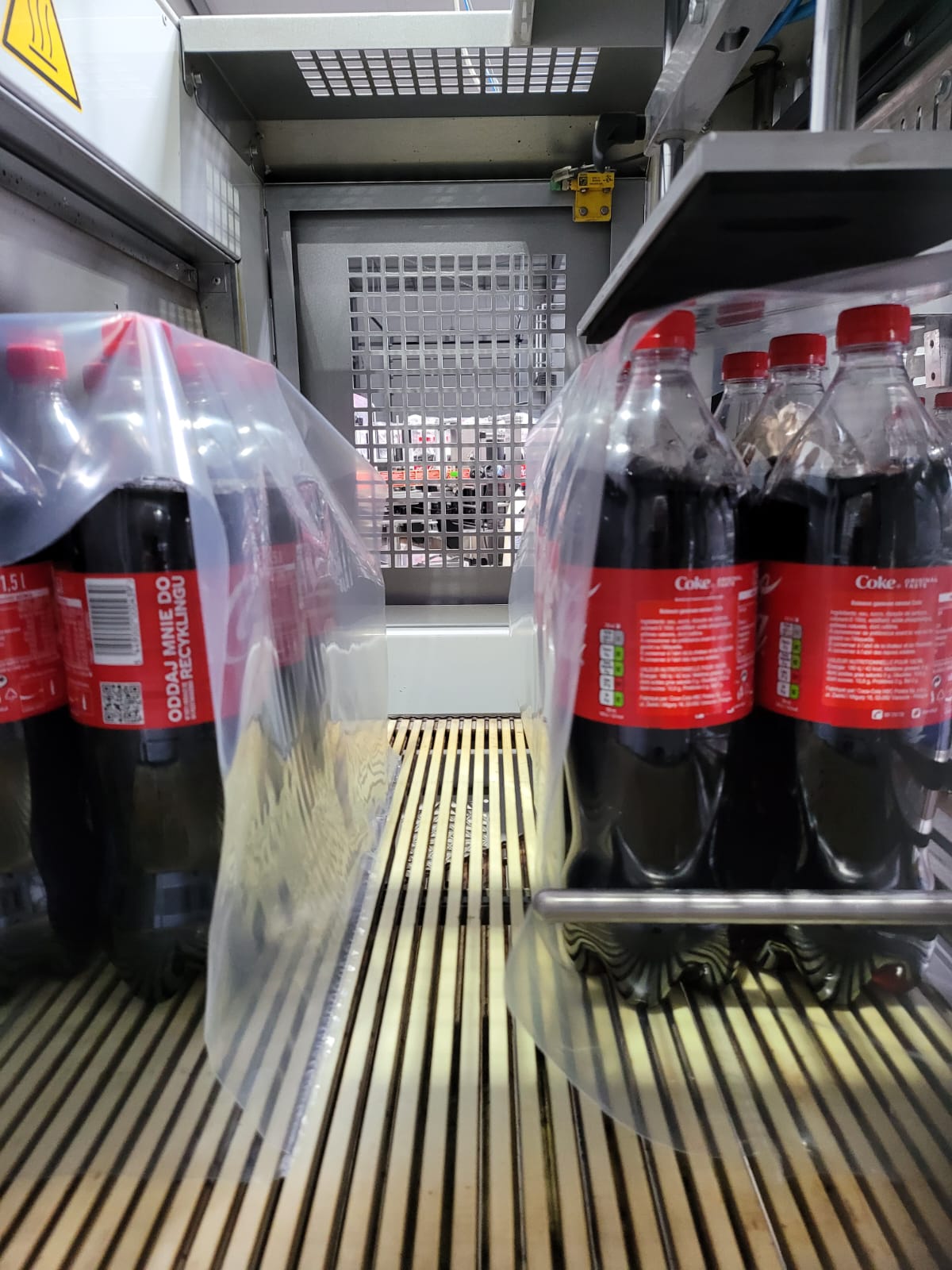 1.5L bottles Polish Coca Cola during machine pacing into 6 pack